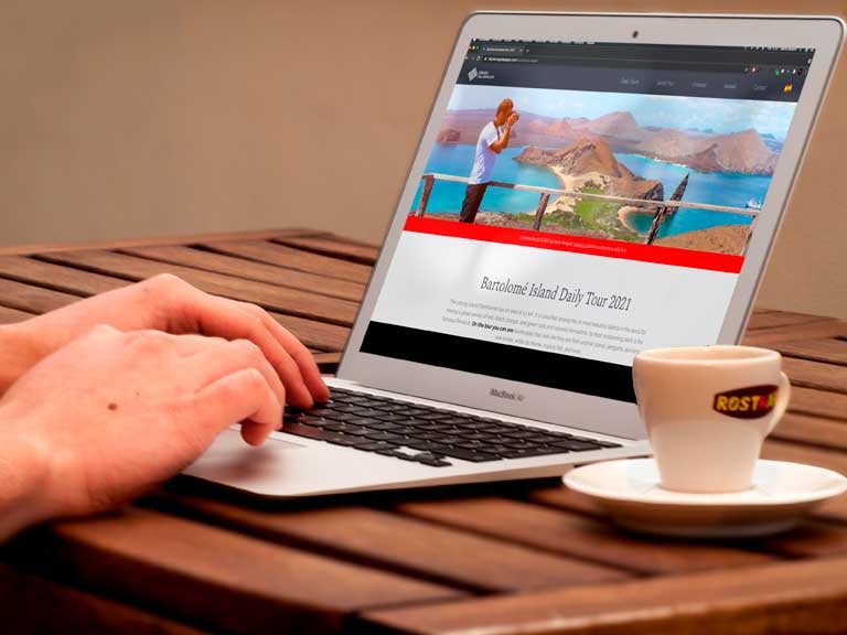 Laptop sobre un escritorio con la página web de Tours Diarios Galápagos